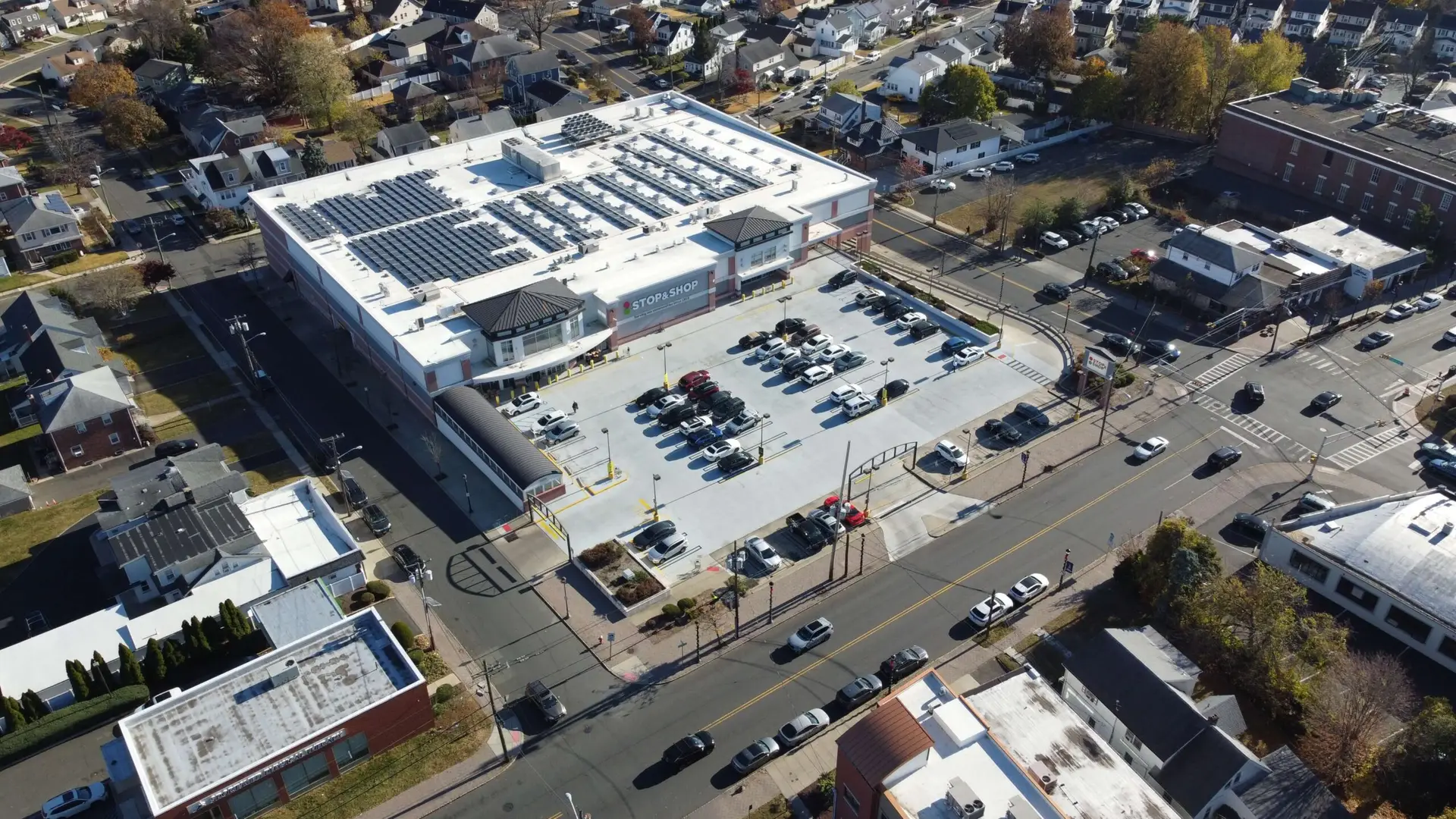 Drone photo showing a parking garage atop a Stop & Shop supermarket in Union, NJ, surrounded by residential streets and urban traffic