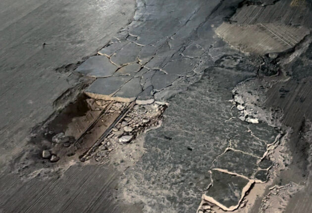 Extensive cracking and delamination in concrete exposing rusted rebar, a critical structural issue often due to water damage and freeze-thaw cycles