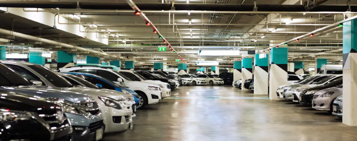 A clean, fully restored underground parking garage featuring bright lighting, clear markings, and modern design elements
