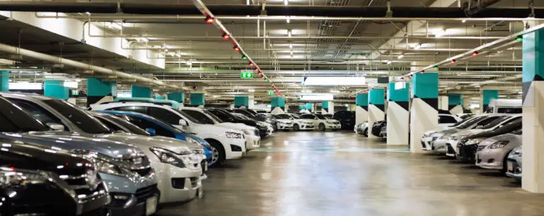 A clean, fully restored underground parking garage featuring bright lighting, clear markings, and modern design elements