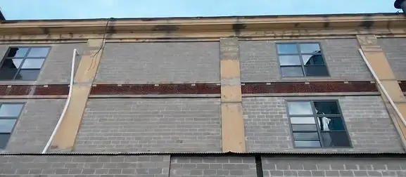 Reconstruction of the exterior facade with new masonry and window installations at the Mack Truck Plant in Plainfield, New Jersey