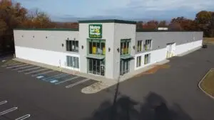 Ground-level front view of Metro Self Storage in Springfield, NJ, showing entrance, green trim, glass doors, and handicap-accessible parking