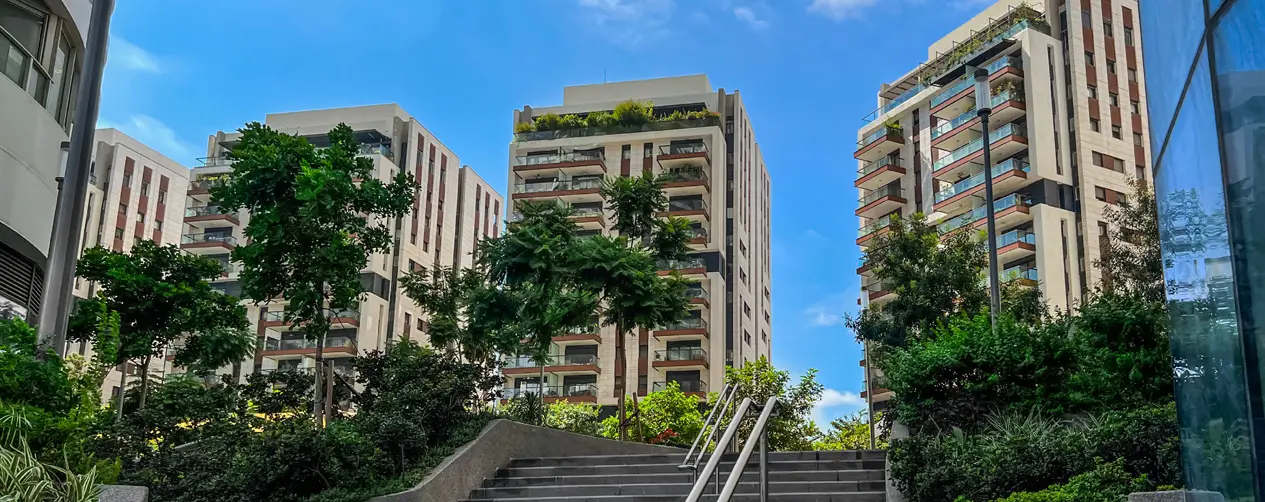 Modern multifamily buildings with green roofs and lush landscaping designed for energy efficiency