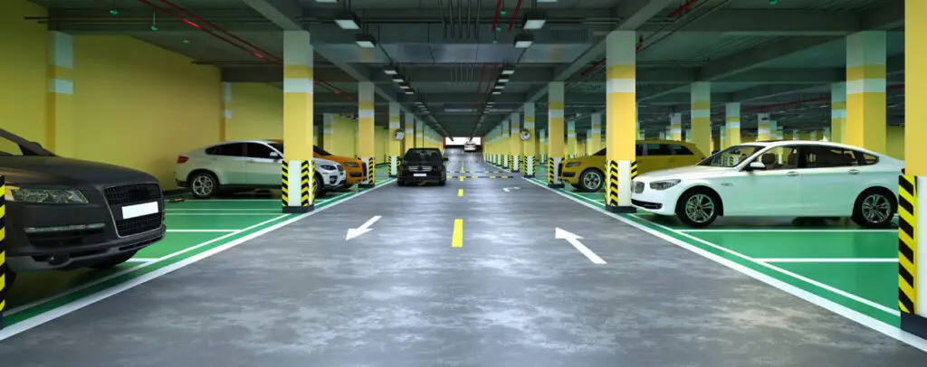Waterproofed parking facility with clear directional arrows and well-maintained floor and walls